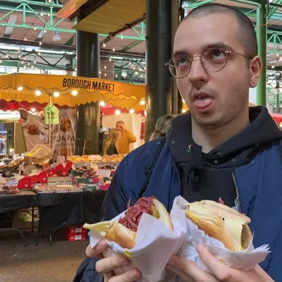 A man holding two salt beef sandwiches at Borough Market in London