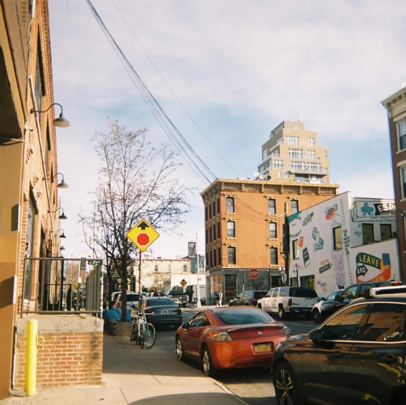 Philadelphia neighborhood street corner with brick rowhouses