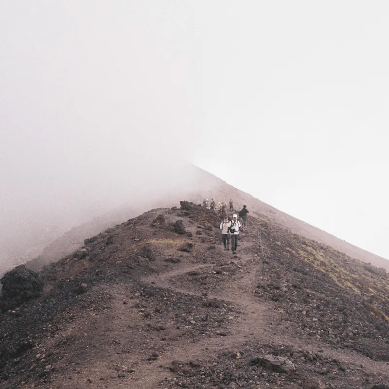 A group of hikers descending a rocky slope in the Daisetsuzan volcanic massif in Hokkaido